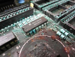 Image shows a heavily corroded circuitboard.