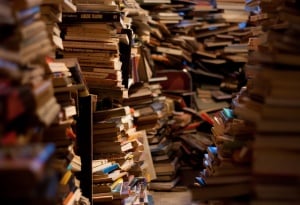 Image shows huge piles of books. 