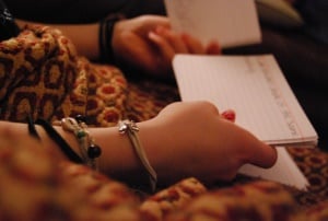 Image shows a woman's hands, flicking through flashcards.