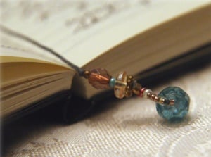 Image shows a beautiful old-fashioned notebook with a beaded bookmark.