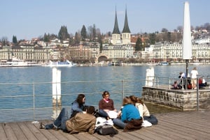 Image shows a group of students studying by a river in Switzerland.