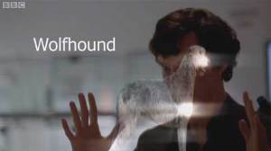 Image is a still from the BBC drama Sherlock, showing Sherlock visualising a wolfhound.