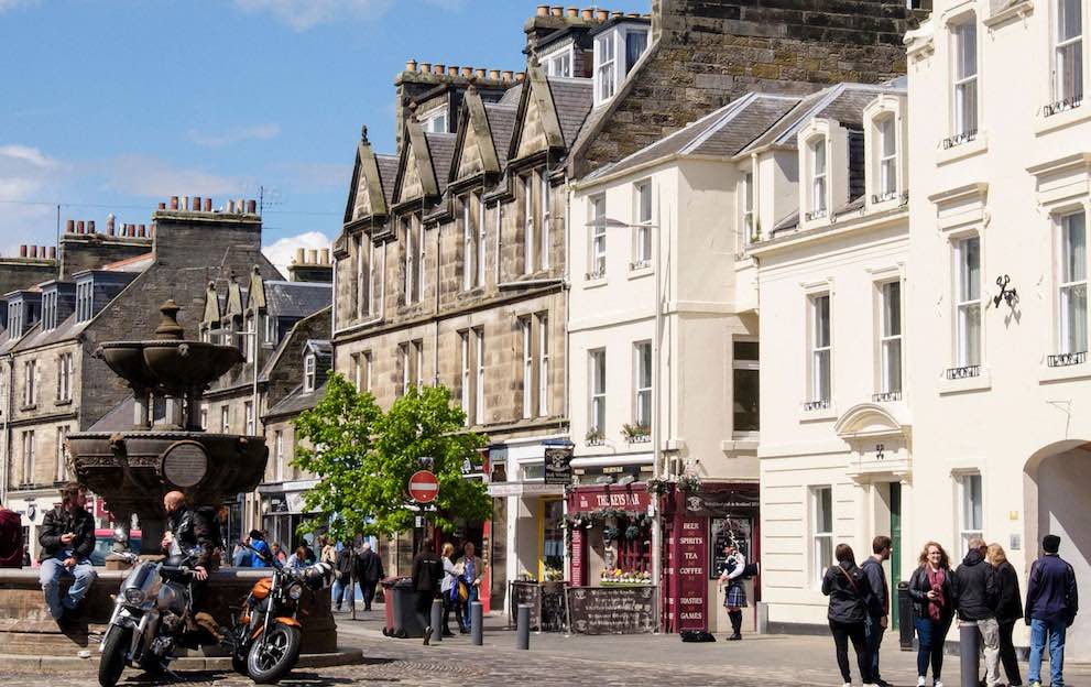 A view of small shops on a cobbled market street in St Andrews